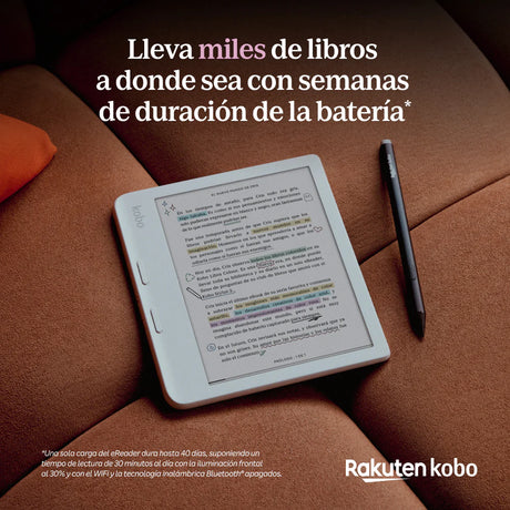 El eReader Kobo Libra Color 32GB Negro con pantalla a color E Ink descansa sobre un sofá junto a un bolígrafo, mostrando un libro subrayado y anotado. Destacan su batería de larga duración y 32 GB de almacenamiento para millas de libros.