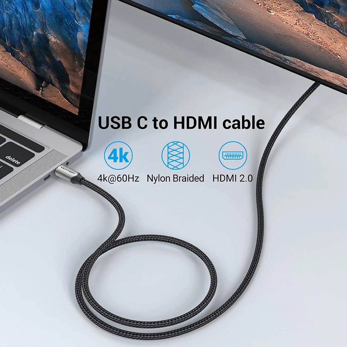 Cable USB-C a HDMI 2 m Vention con malla de nylon trenzado conectado al puerto USB-C de un MacBook