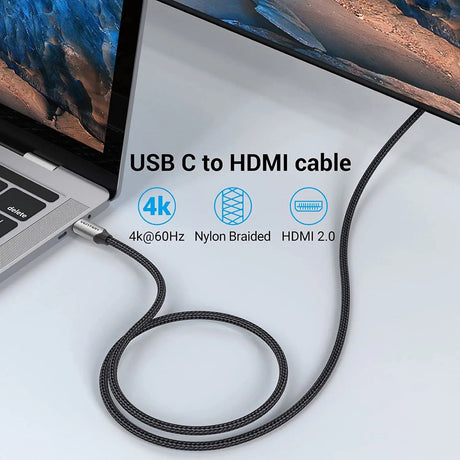 Cable USB-C a HDMI 2 m Vention con malla de nylon trenzado conectado al puerto USB-C de un MacBook